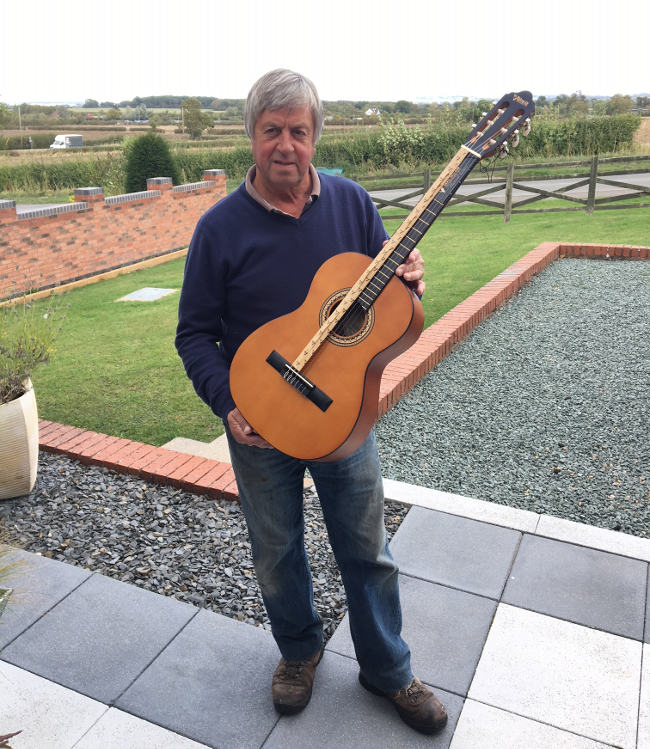 Gordon Clarke holding one of the guitars